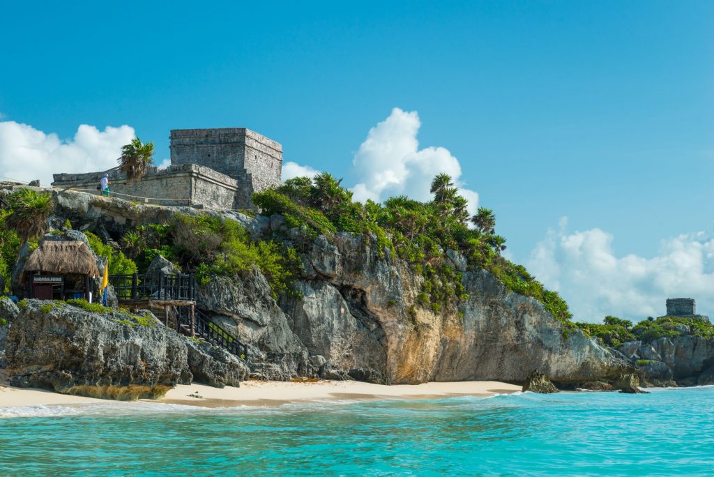 Foto El Castillo, das Hauptstück der alten Maya-Ruinen in Tulum, Mexiko, liegt auf dem Felsen mit Blick auf das karibische Meer. Ein Highliht einer nachhaltigen Reise nach Mexiko.